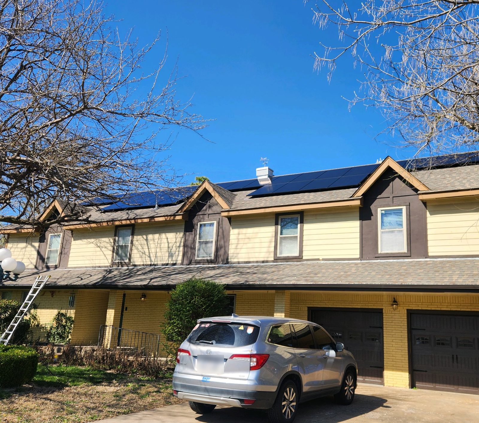 Solar panels along the upper roof of a two-story home